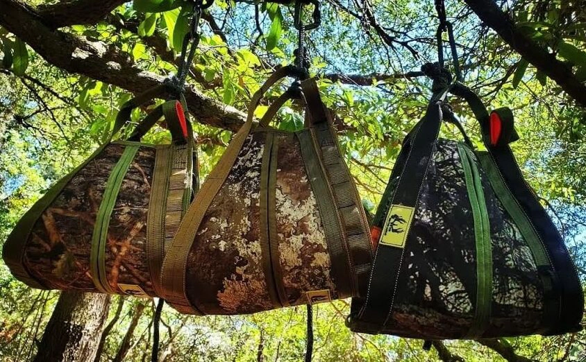 Bags securely attached to rope hanging from a branch